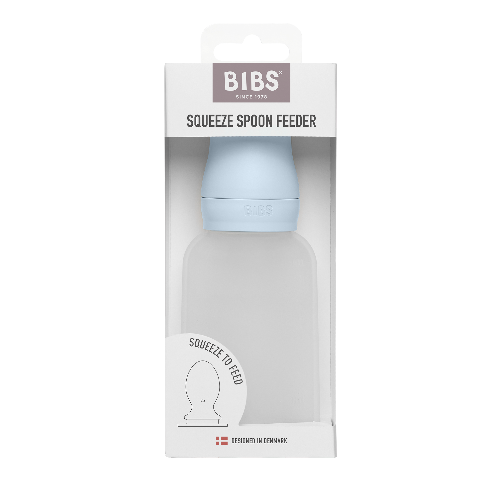 BIBS szilikon adagolós etetőkanál pasztellkék színben az eredeti ablakos papírdoboz csomagolásában szemből nézve.