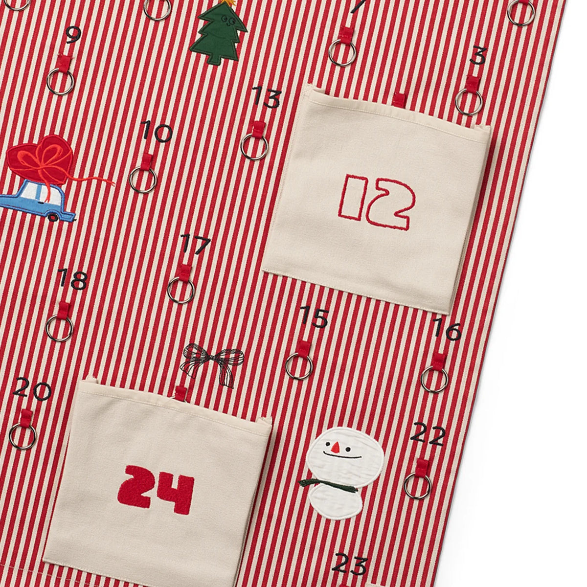 Liewood Blaise adventi naptár közelről: hímzett 12-es és 24-es zseb, hóember és fém karikák